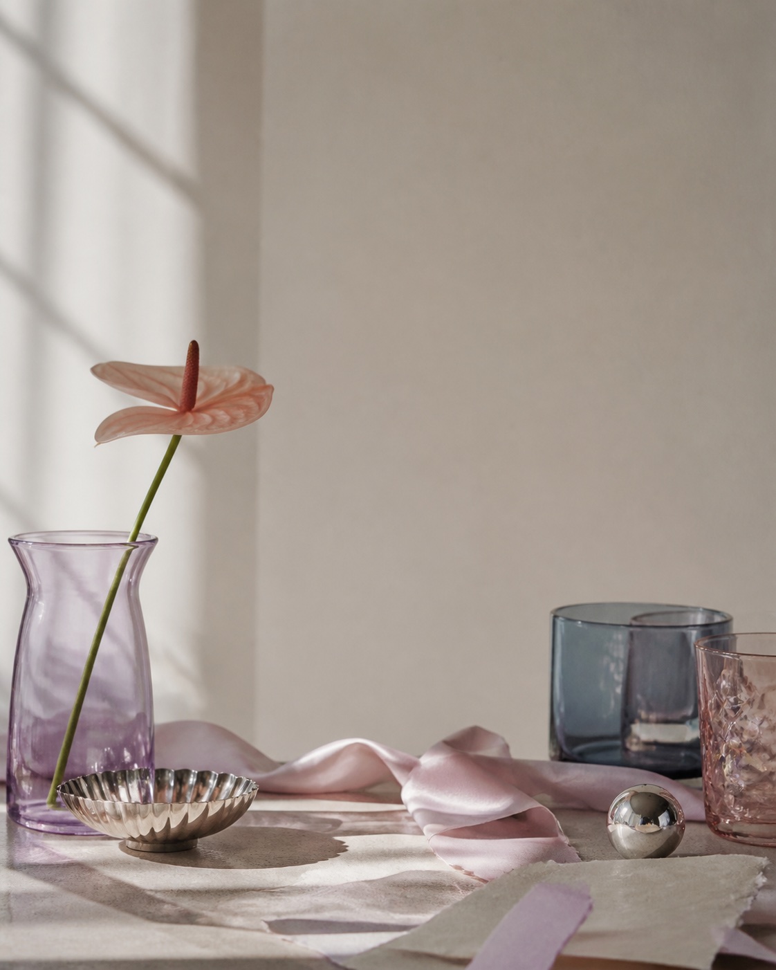Pink glass and ribbon still life